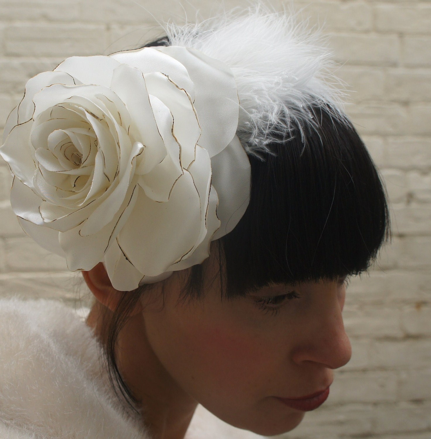 White wedding rose and feather headpiece for a bride made from recycled satin
