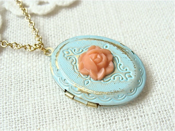 Weathered vintage style locket necklace. Antique blue with a coral rose and golden chain. Jewelry by Sweet And Simple.