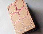 as seen in BGH pink circles stitched moleskine notebook, lined pages