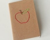 stitched moleskine notebook, red apple for the teacher (graph pages)