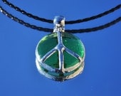 Translucent green glass bead peace pendant