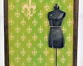 WALL PLAQUE covered in old paper with 3-d vintage dress form