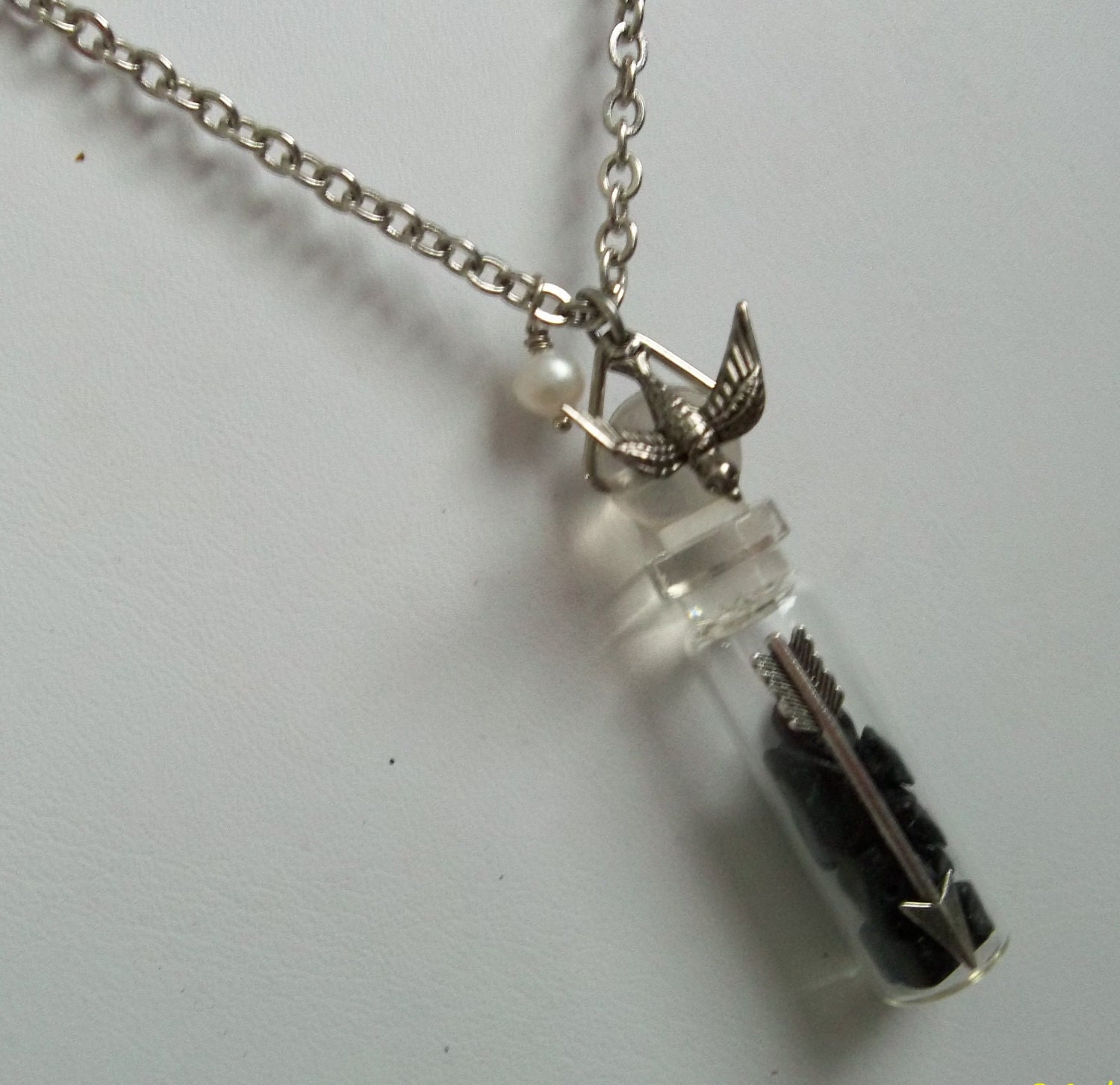 Hunger Games district 12 vial necklace with coal and Peeta's Pearl and Katniss Arrow Mockingjay