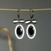 Oval black and white enameled earrings
