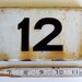 vintage enamel house number from Europe, number 12 black on white with great patina