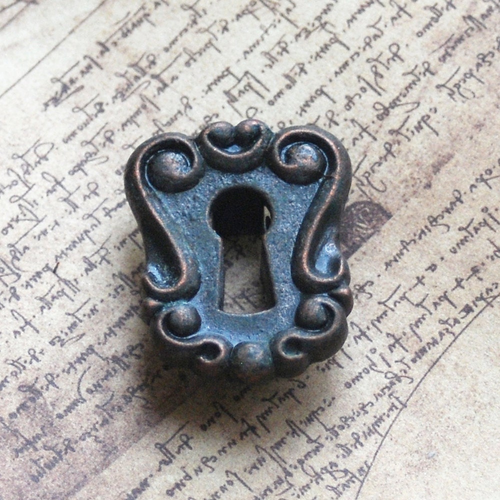 ESCUTCHEON...  vintage key hole plate...  L