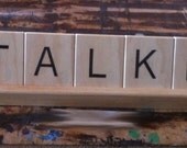 Large pieces of wood with letters on them on a rack