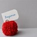Red yarn pom pom place holders.  Wedding decor, party favors, pom poms