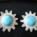 Silver tone sunburst clip back earrings with faux turquoise blue center stone. VIntage earrings