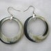 Round hoop earrings with subtle shadings of black khaki & white