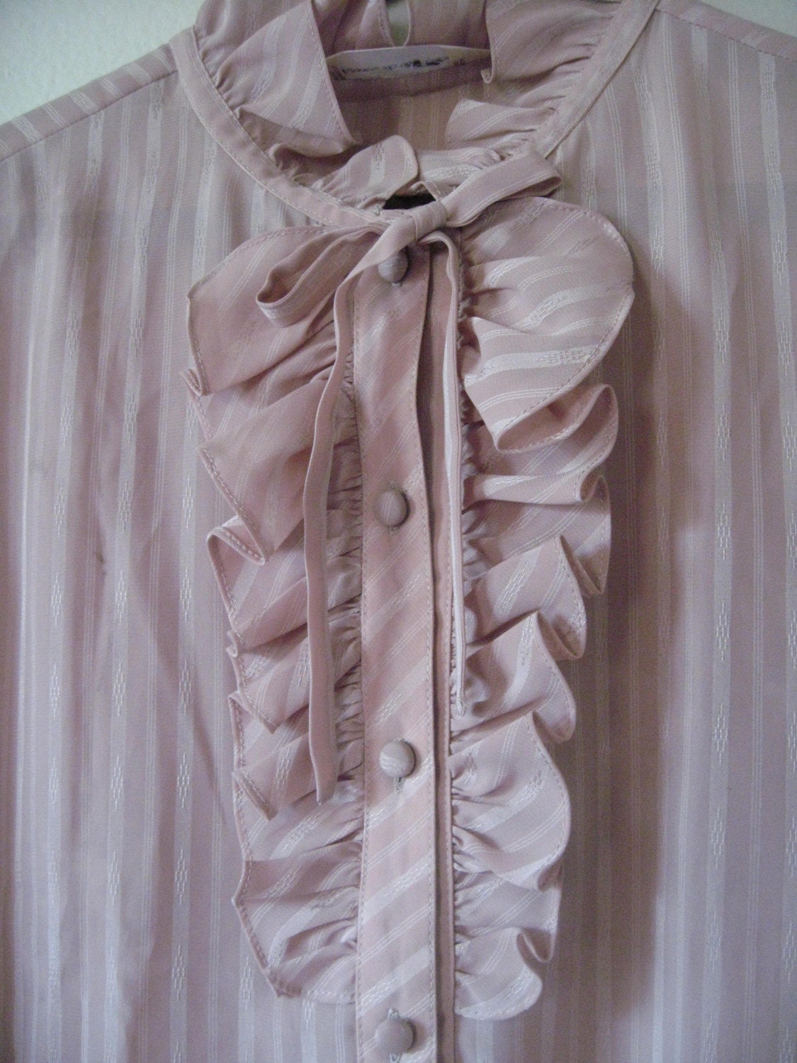 Vintage 80s long sleeve beige blouse with ruffle accents.