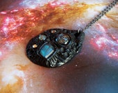 Black polymer clay pendant with labradorite and dichroic glass cabochons