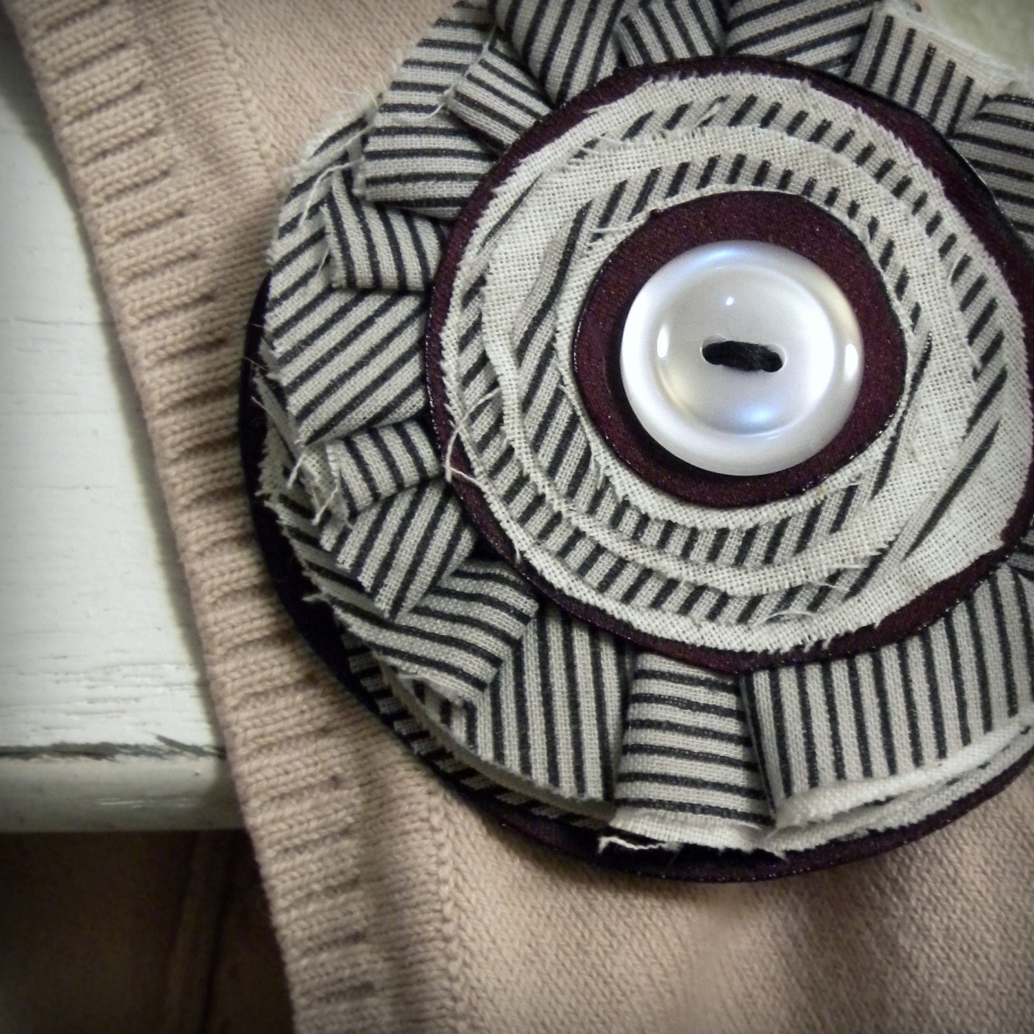 pinwheel brooch, pinstripes and burgundy