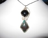Rare Cuprite and Black Onyx hand wrapped in sterling silver.