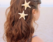 Two small white knobby starfish barrettes.