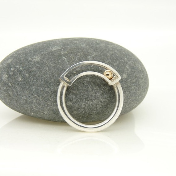 Items similar to Rolling Ring in Sterling Silver with 9ct Gold