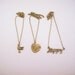 Set of three friendship necklaces. Peace, love, happiness. Brass, gold toned. Dove. Heart with flower. Best friend gift.