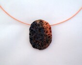 Choker with a ceramic pendant in amber and black
