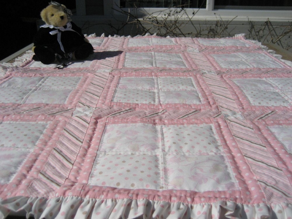 Pink baby quilt with ruffles and lots of hand quilting.