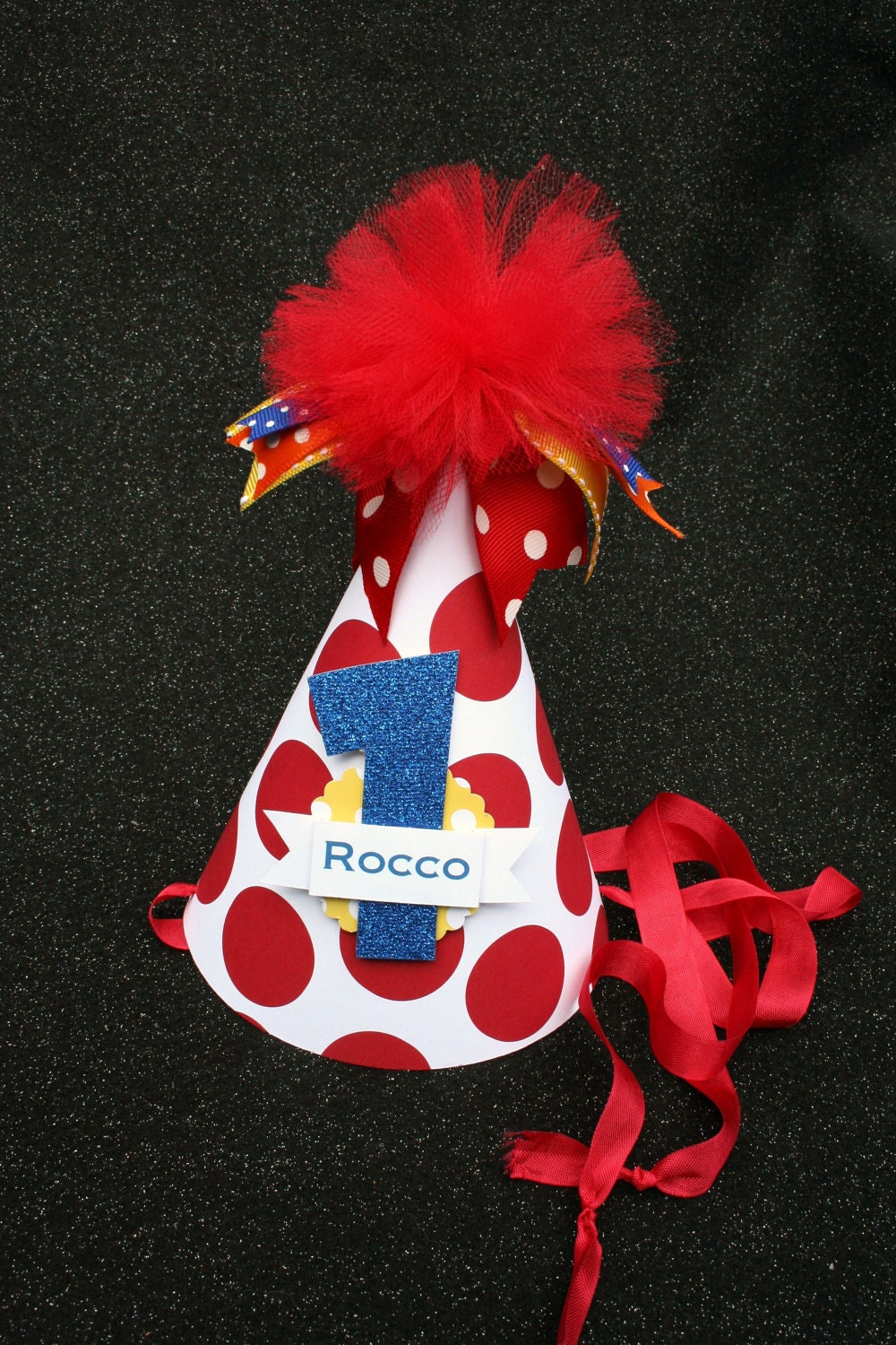 Little Dude birthday party hat in big red polka dot with blue yellow and orange