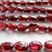 Garnet smooth oval nuggets, 8" inch strand, 28 beads 5.5mm - 8mm (wsgo1-3)