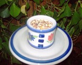 Teacup birdfeeder poke creates a charming addition to your flower garden