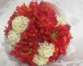 Ivory button mums mixed with orange mums, poppies, and gerbeta daisies make up "Autumn Ablaze" kissing ball.