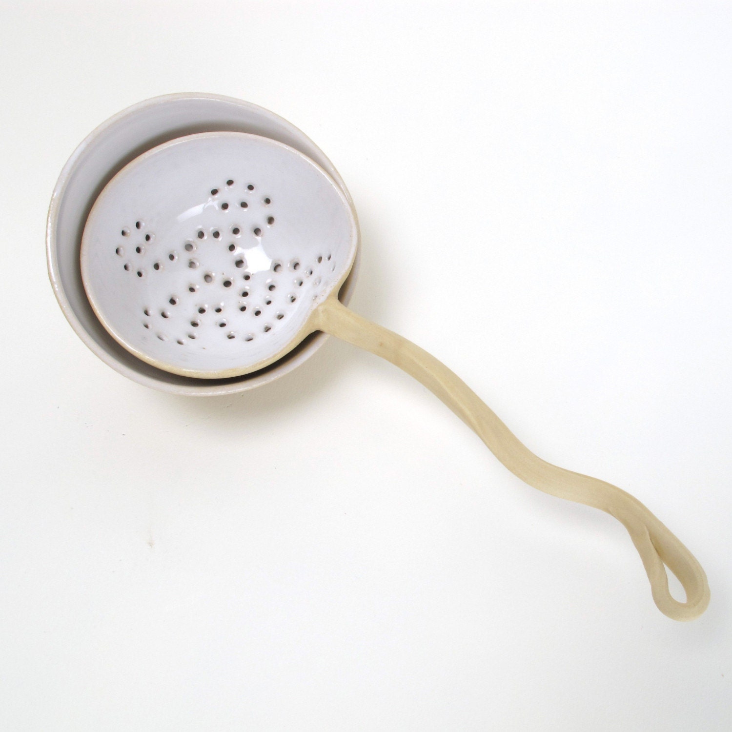 Beautiful tea strainer  with curled grip with a fitting bowl