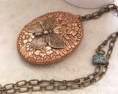Butterfly In Motion, 70s vintage copper and brass locket necklace with glass butterfly beads