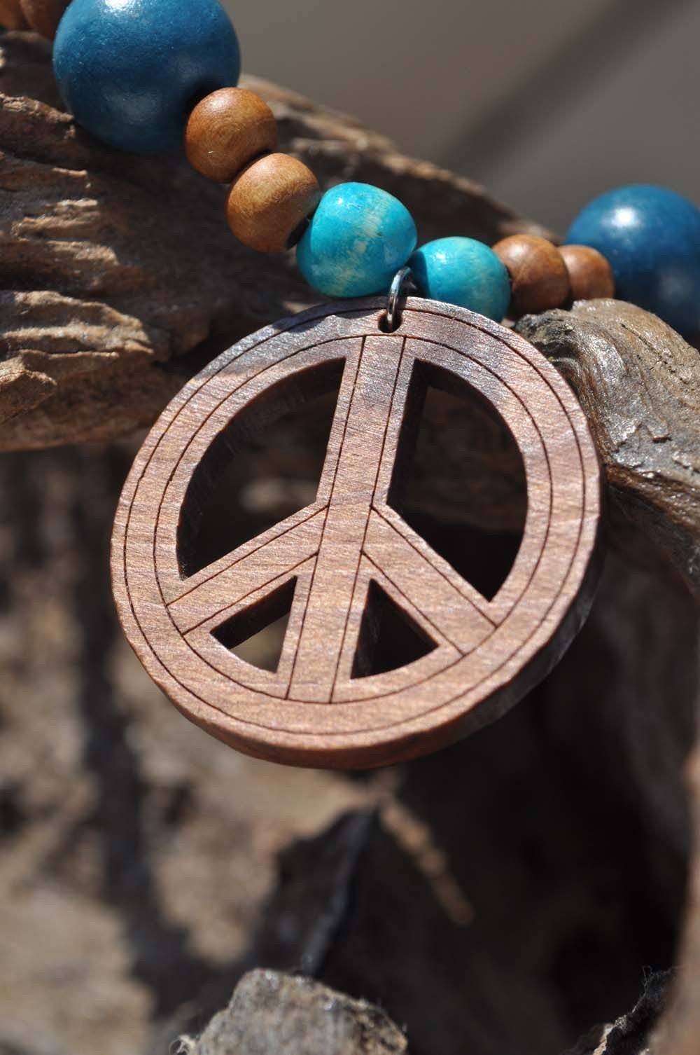 Wooden necklace with peace sign in blues and browns