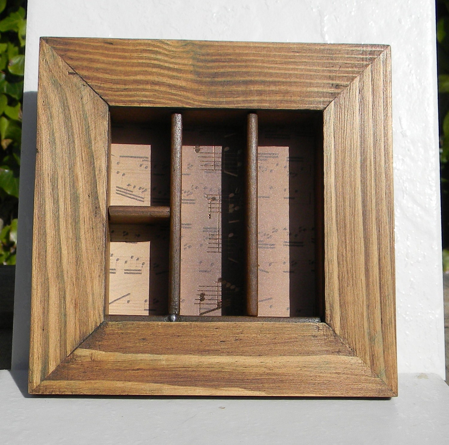 Part printer's type case in a frame, display thimbles, etc. featuring music.