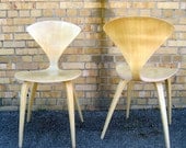 A pair of mid century modern blonde chairs