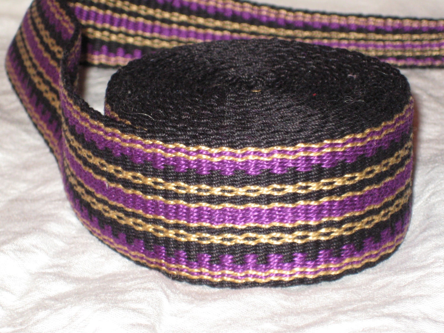 Black, purple, and gold inkle woven trim