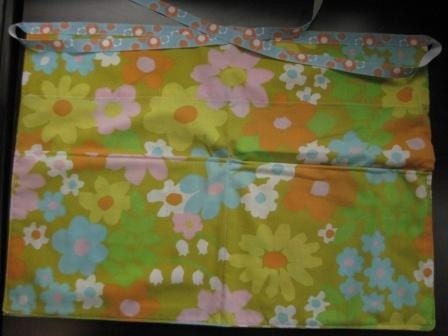 Vintage floral sheet apron.  Retro mod yellow floral apron with pockets handmade from vintage pillowcase.  Ribbon ties around waist..
