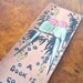 1920s bookmark / "A book is good company" with a pair of parakeets / leather book mark