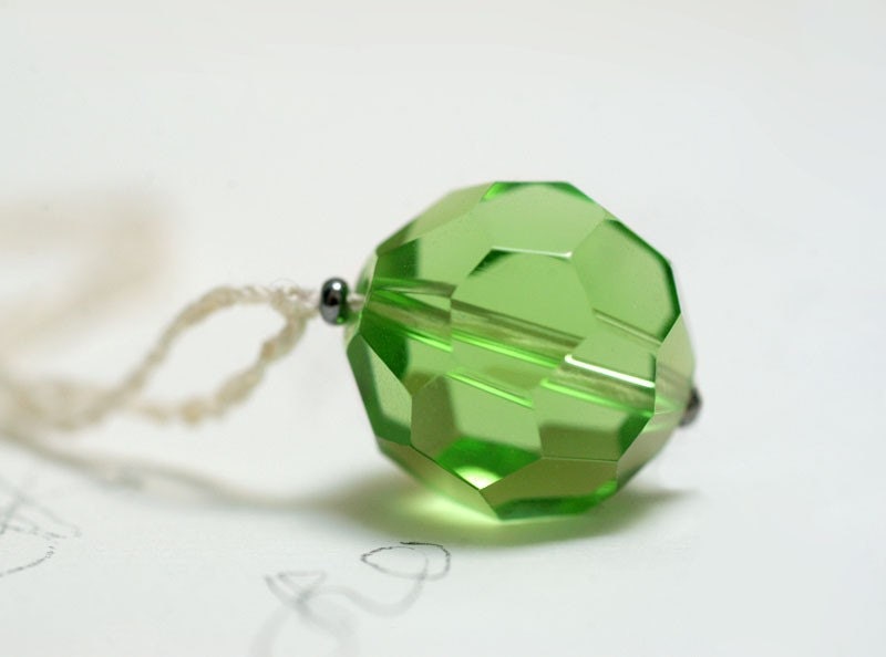 Green olive leaf glass pendant on crocheted thread