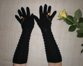 Hand-knitted black gloves with hand-needlecrafted yellow flower for women