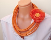 Orange fabric loop necklace with flower brooch