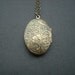 vintage two sided victorian style floral pattern oval locket - antique brass