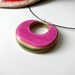 pink recycled wood reversable pendant on a wire necklace