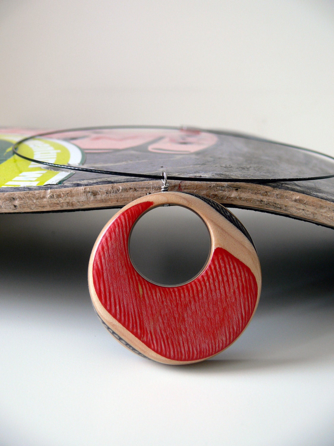 Red and Black Recycled Skateboard Wood Pendant on a Black Wire Necklace with Purple Ivy Graphic