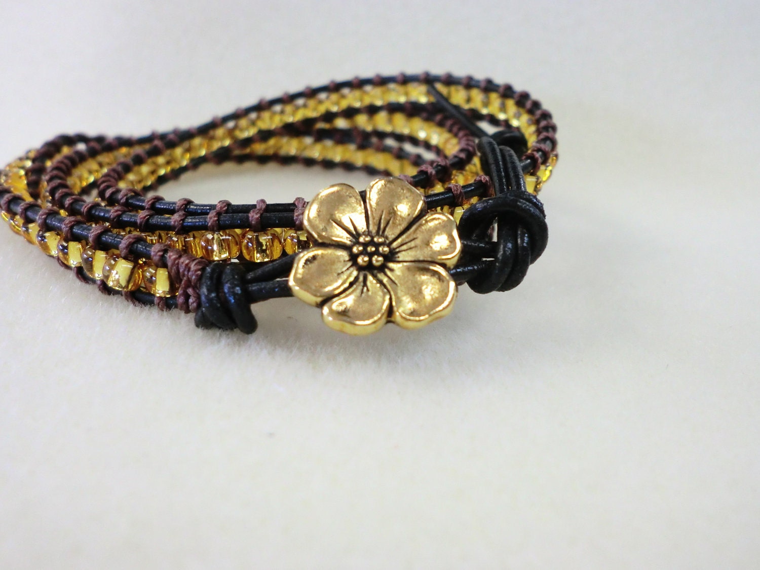 WrapLet, Gold on Black leather with gold flower button