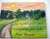 An ispirational sign with an original painting of a landscape with a meandering path
