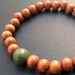 Mens light brown wooden beaded stretch bracelet with semi-precious green jasper bead
