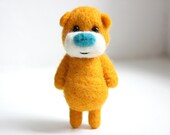 Orange pocket bear with a kinda blueish nose