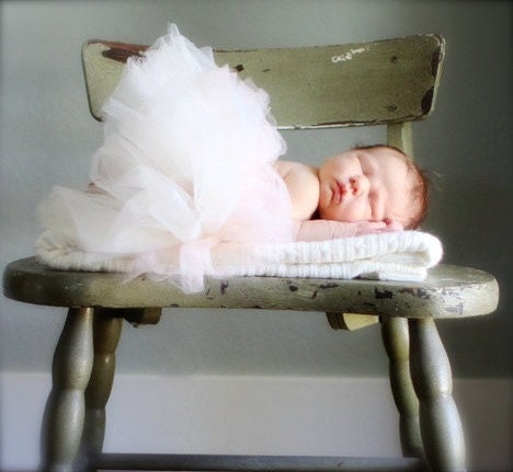Newborn baby tutu classique perfectly proportioned with blossom hair clip. Soft ethereal tutu in classic ivory and nursery decoration.