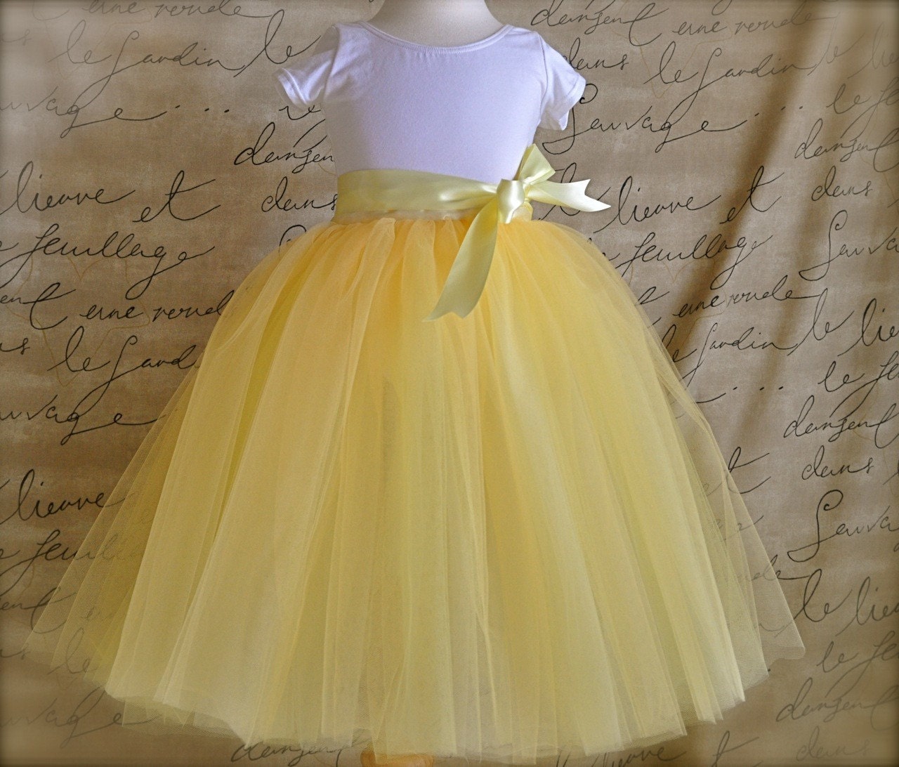 The Daffodil Tutu for Flower Girls. Six layers of butter yellow, lemon yellow and ivory tulle is sewn.