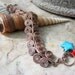 egyptian coil bracelet in copper with turquoise and coral