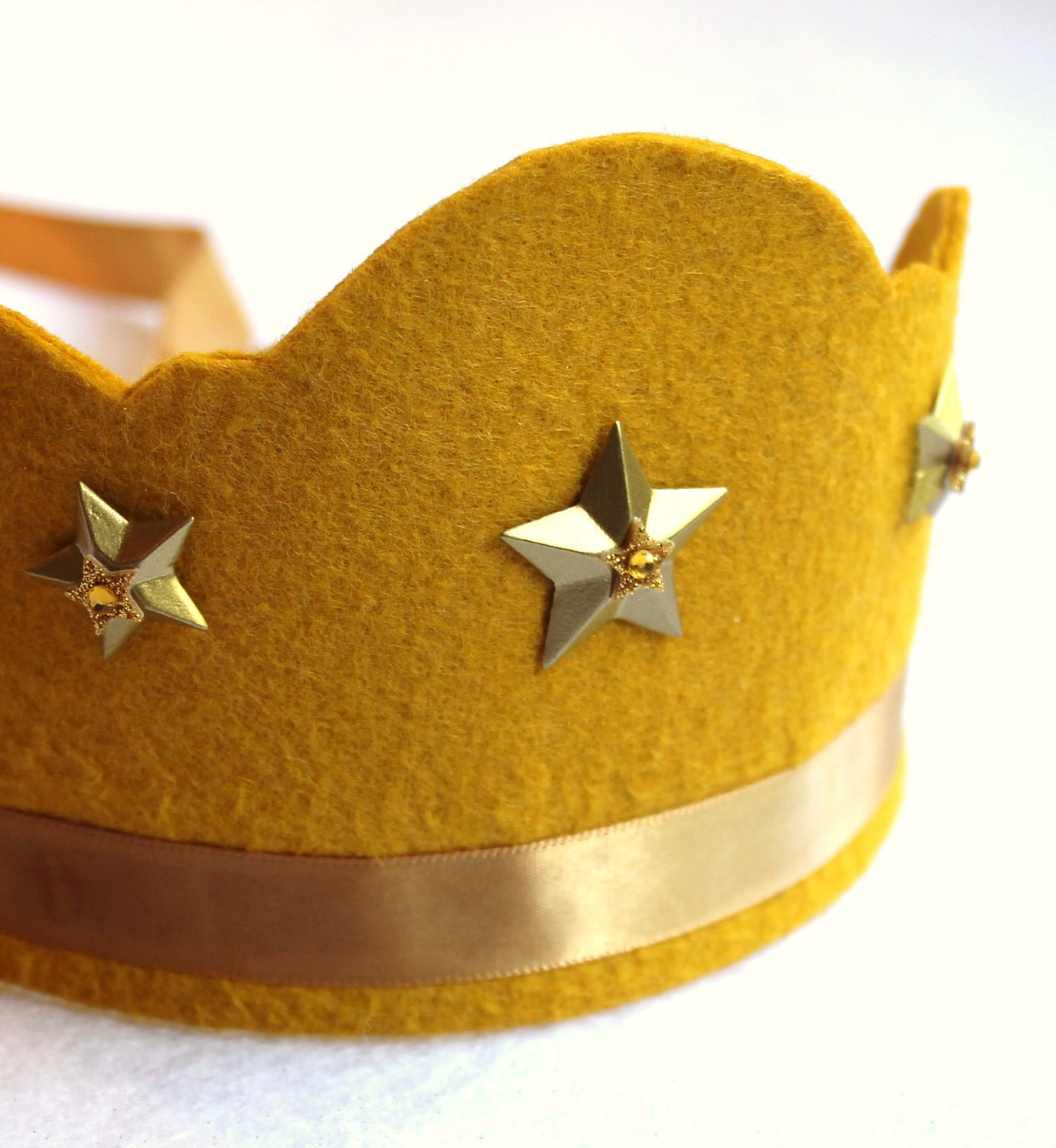 20% wool blend scalloped cut stella felt crown with gold stars and adjustable ribbon tie.  party, play, shine.