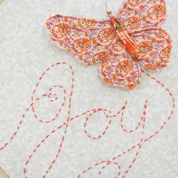 Butterfly Embroidery Hoop - Joy Flutters In - hand embroidered 10" wall hanging in peach, coral pink, beige, white, and lilac